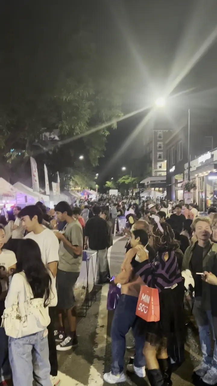 An outdoor night-market crowd enjoying the evening