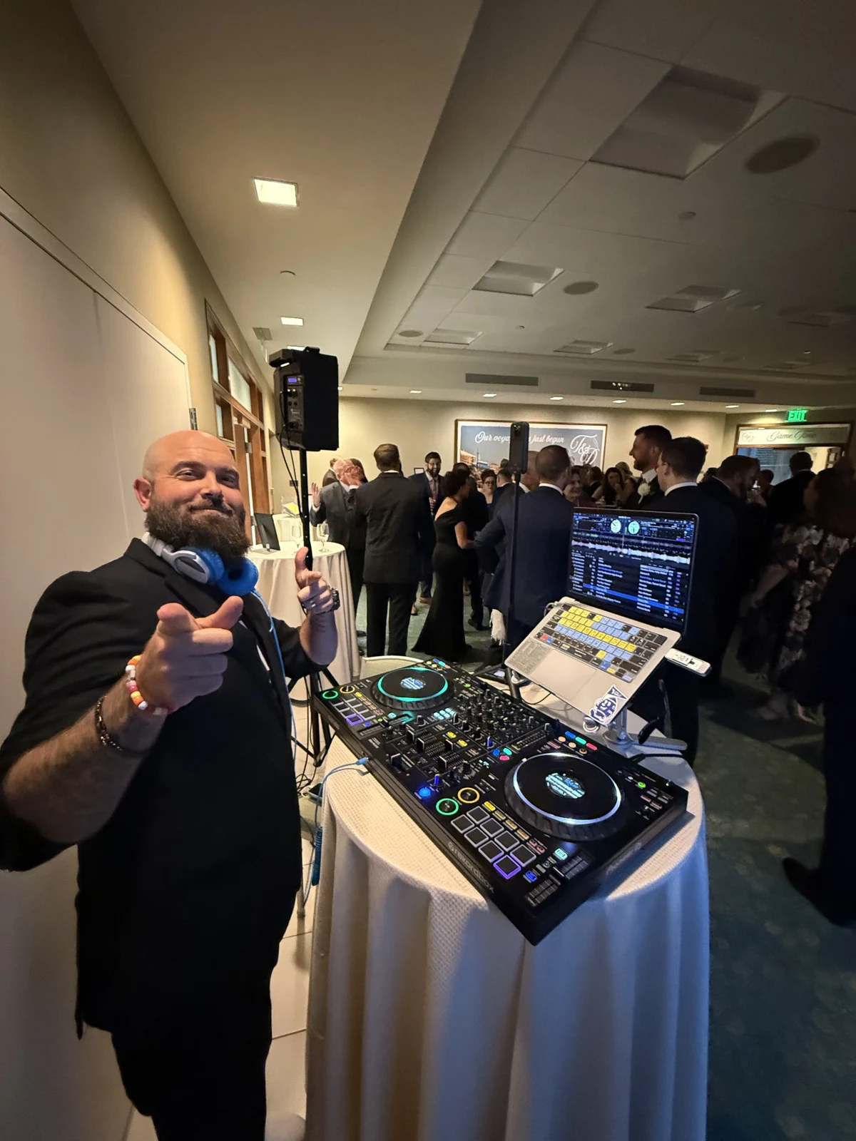 Kyle at the DJ booth during a formal indoor event