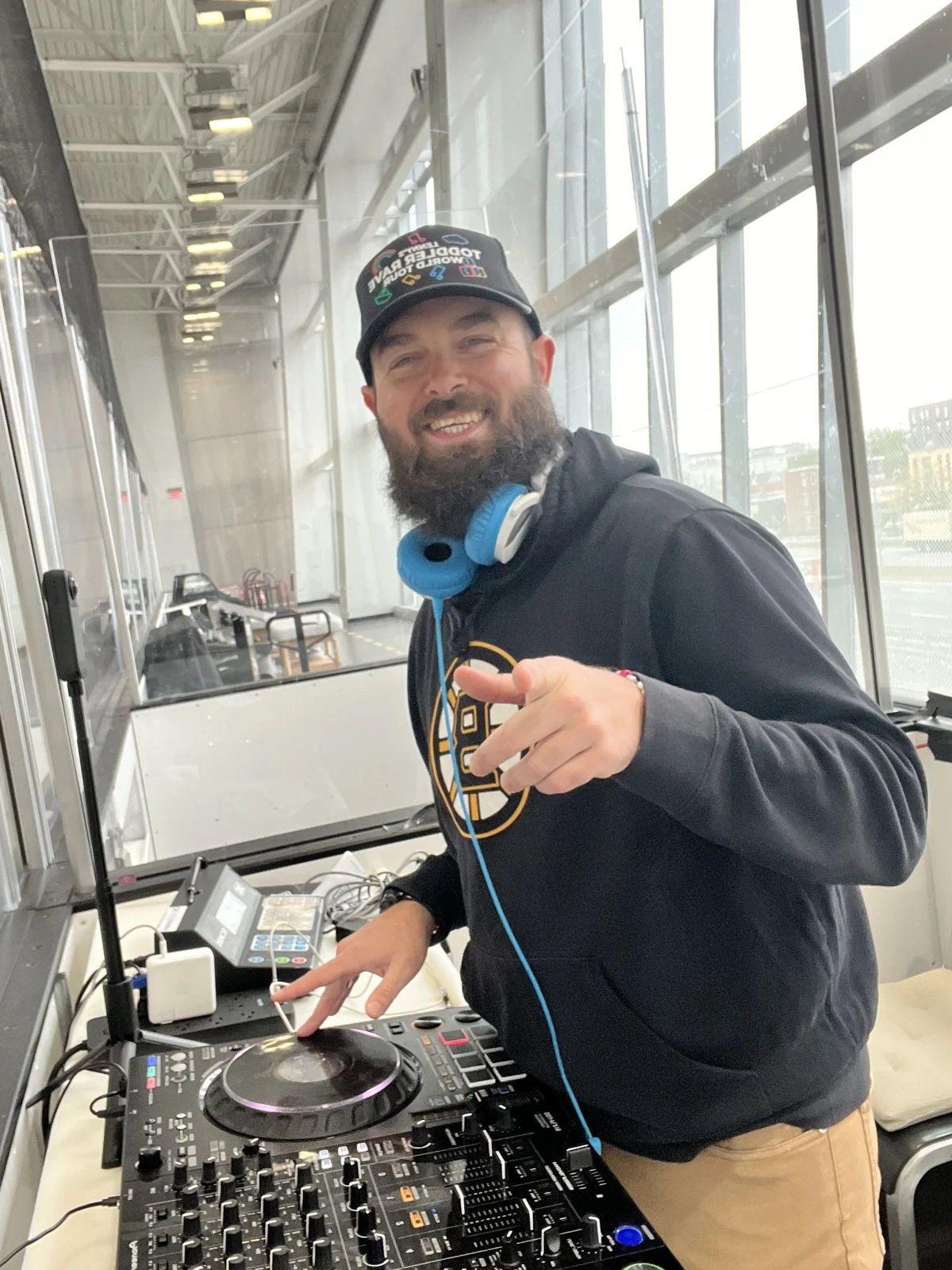 Kyle in headphones, focused on the music behind the DJ decks