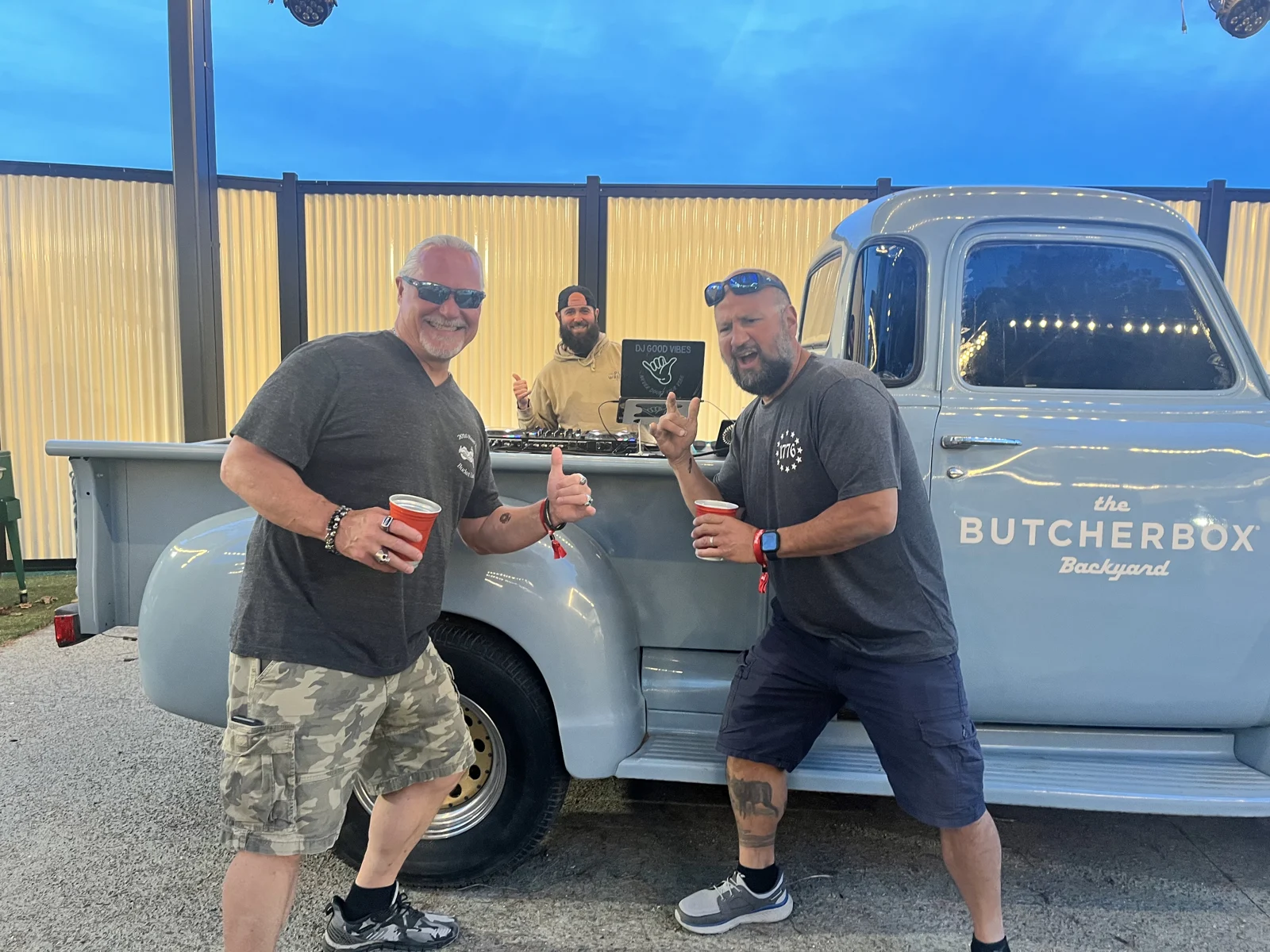 Kyle with guests beside the blue DJ truck at Xfinity Center